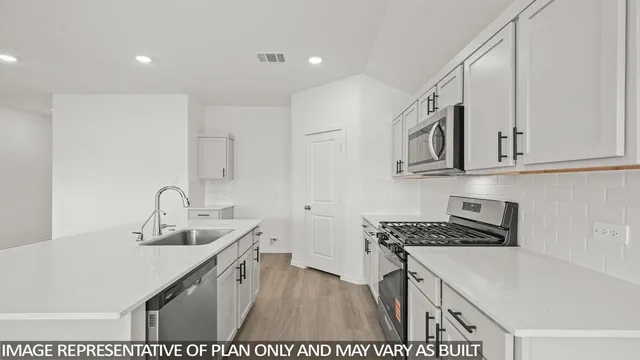 a kitchen that has a sink and a stove