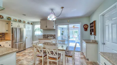 a kitchen with stainless steel appliances a refrigerator and a stove top oven