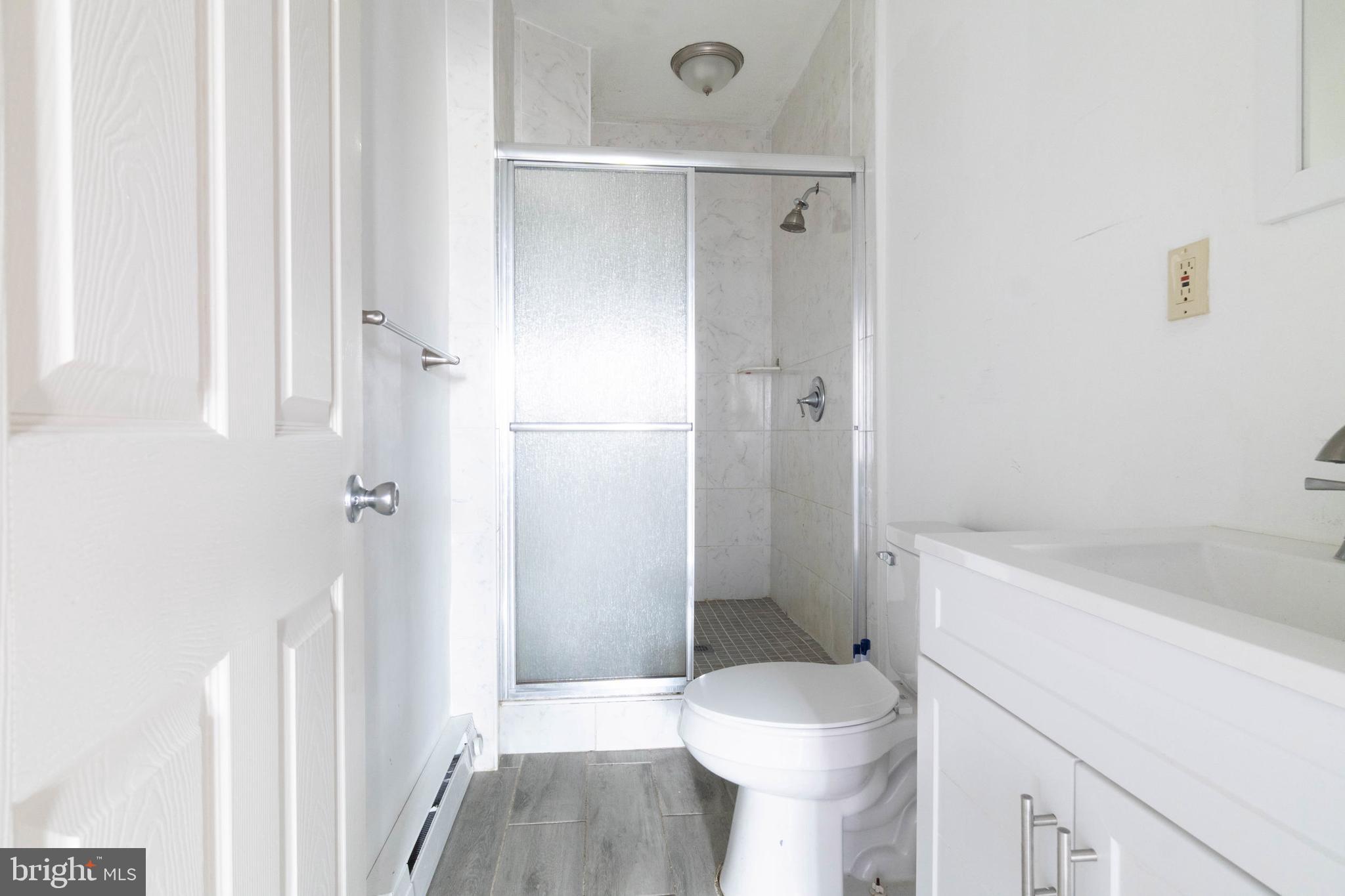 2506 Tindaro Terrace Atlantic City, NJ 08401 - Photo 8 of 14 a bathroom with a sink a toilet and shower