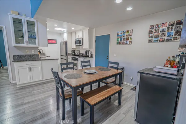 a kitchen with stainless steel appliances granite countertop a sink stove and cabinets