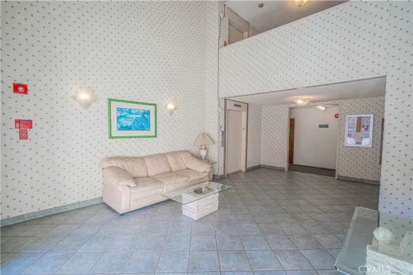 a bedroom with a bed and a lamp