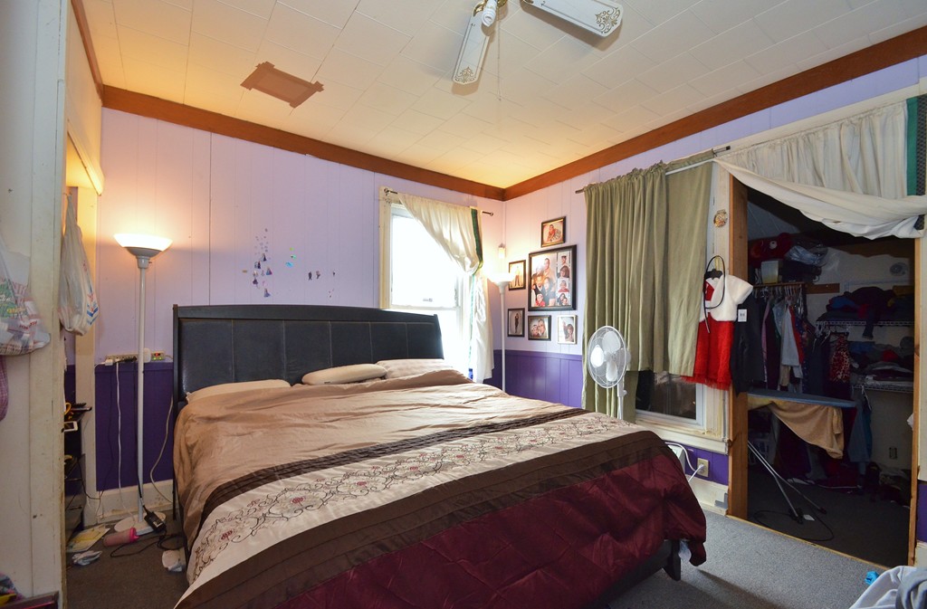 25 Ripley Street Worcester, MA 01610 - Photo 6 of 17 a bedroom with a bed and a walk in closet