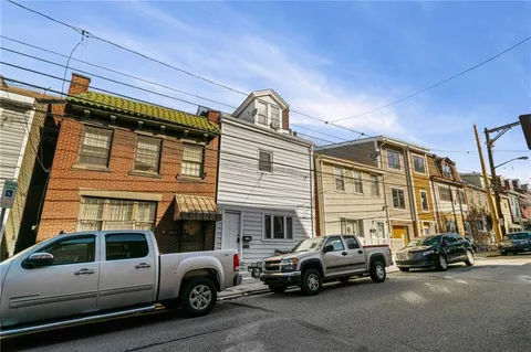 a view of a cars park in front of a house