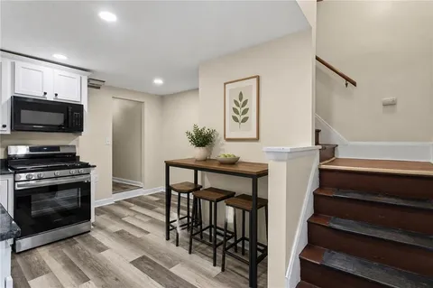 a view of kitchen with furniture and a flat screen tv