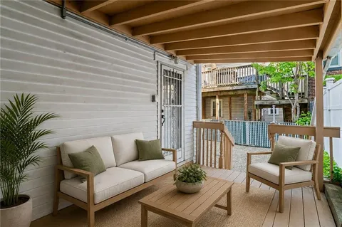 a balcony with furniture and a potted plant