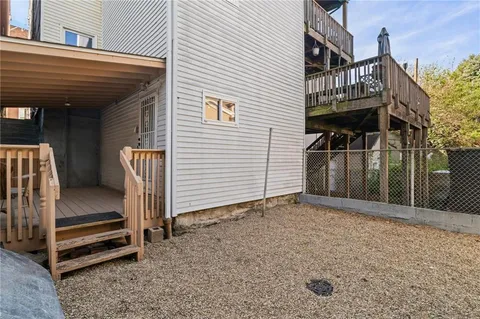 a view of a house with a yard and wooden fence