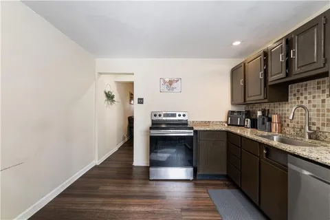 a kitchen with a sink cabinets and stainless steel appliances