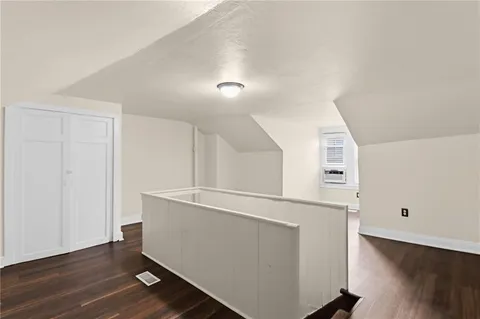 an empty room with wooden floor