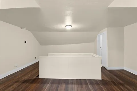 a view of room with wooden floor