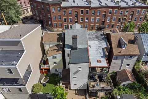 an aerial view of multiple houses with yard