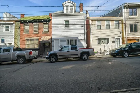 a view of a cars park in front of a building