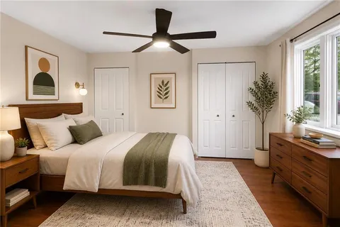 a bedroom with a large bed and a window