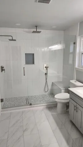 a bathroom with a toilet sink and shower
