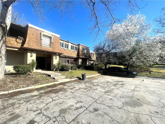 a view of a building with snow on the road