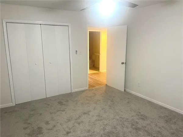 an empty room with closet area