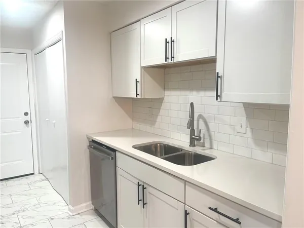 a kitchen with a sink and cabinets
