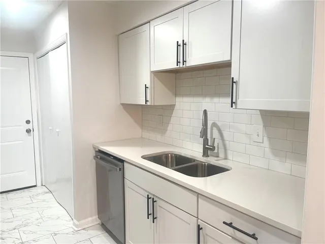 a kitchen with a sink and cabinets