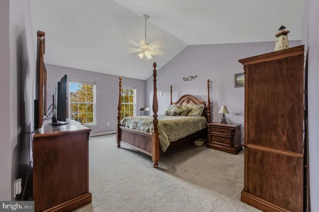 a bedroom with a bed a book shelf and a window