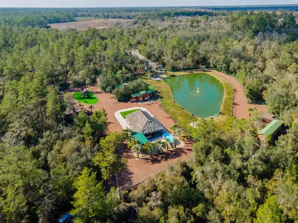 an aerial view of residential house with outdoor space and swimming pool