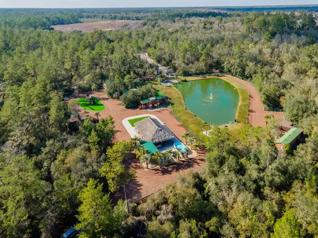 an aerial view of residential house with outdoor space and swimming pool