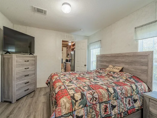 a kitchen with stainless steel appliances a stove and wooden floor