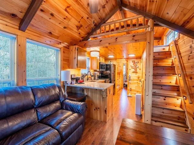 a view of a porch with furniture and wooden floor