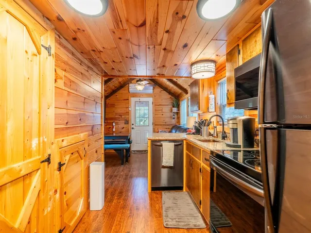 a bathroom with a granite countertop toilet a sink and a mirror