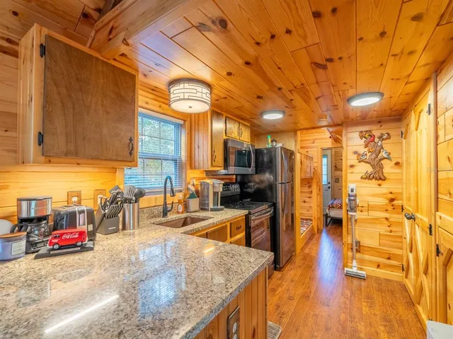 a bathroom with a granite countertop sink and shower