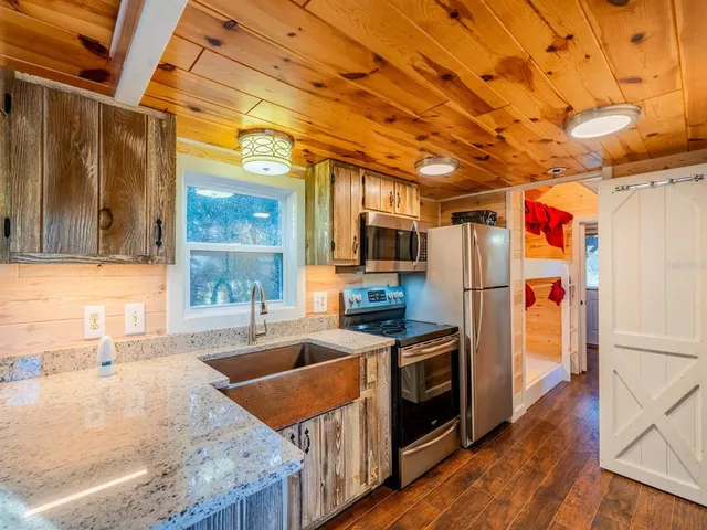a living room with furniture a flat screen tv and wooden floor