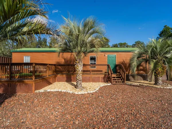 a kitchen with a wooden floor and a fireplace