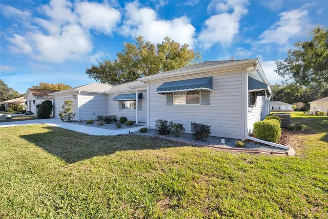 a view of a house with swimming pool and a yard