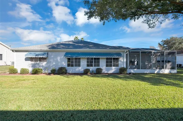 a view of a house with swimming pool and a yard