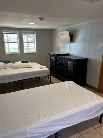 a bedroom with a bed and a lamp