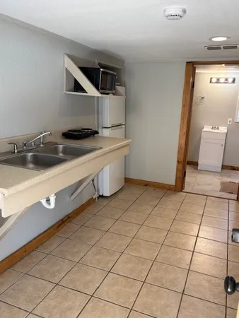 a kitchen with a sink and cabinets