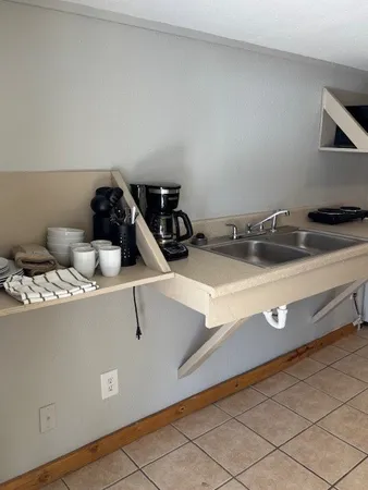 a room with a sink and cabinets