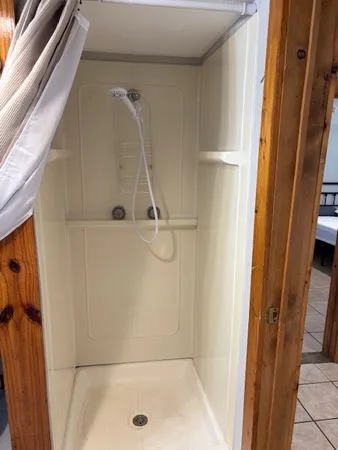 a bedroom with two beds and a dresser