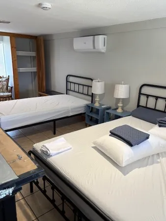 a bedroom with a bed and a window