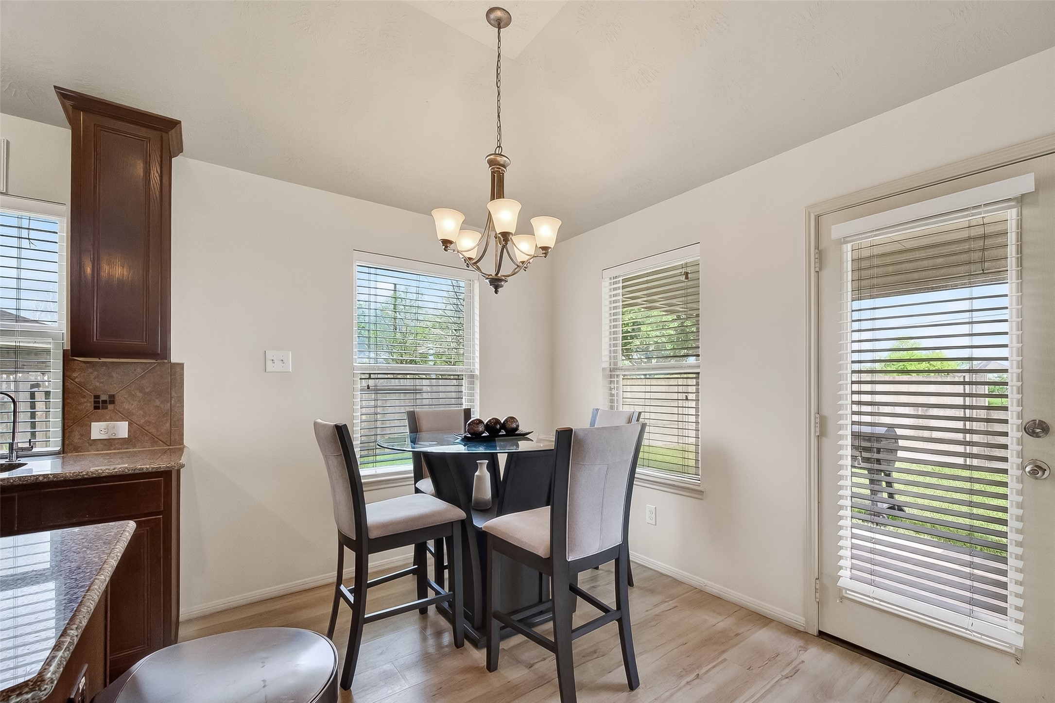 13415 Star Creek Lane Rosharon, TX 77583 - Photo 14 of 46 a dining room with furniture a chandelier and wooden floor