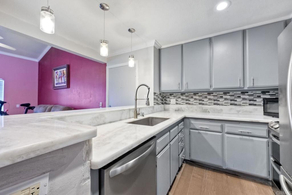 a kitchen with granite countertop a sink cabinets and window