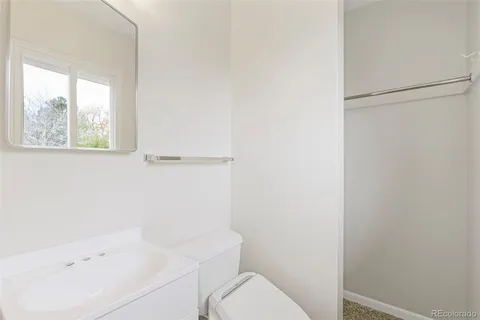 a white toilet sitting next to a bathroom sink