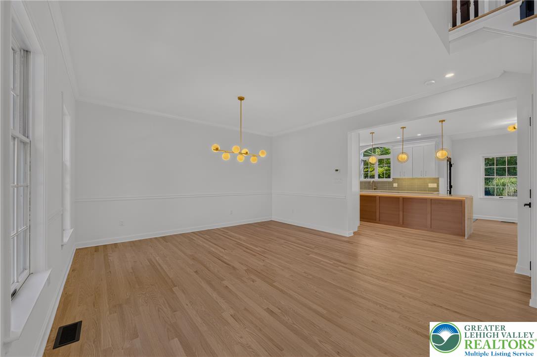 3130 Muirfield Road Center Valley, PA 18034 - Photo 10 of 63 Rich hardwood floors and elegant wainscoting define this formal dining space open to the kitchen.