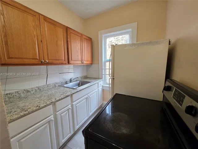 a kitchen with a refrigerator stove and sink