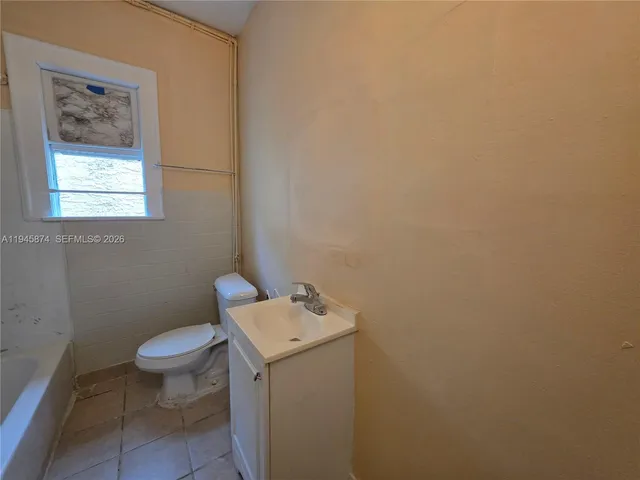 a white toilet sitting next to a bath tub