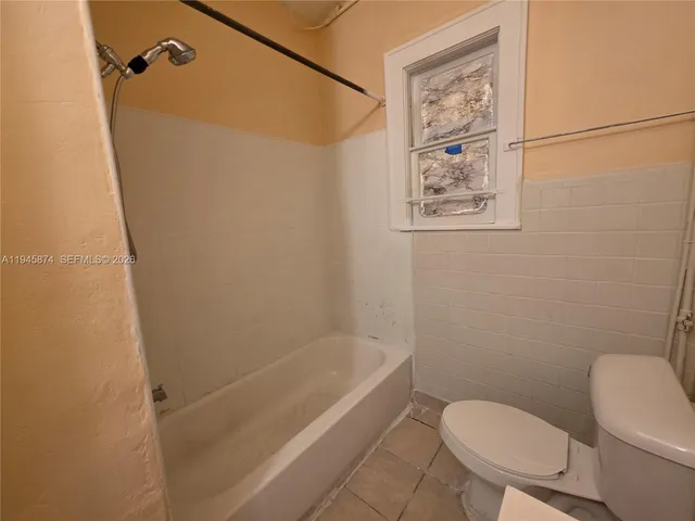 an empty room with windows and entrance