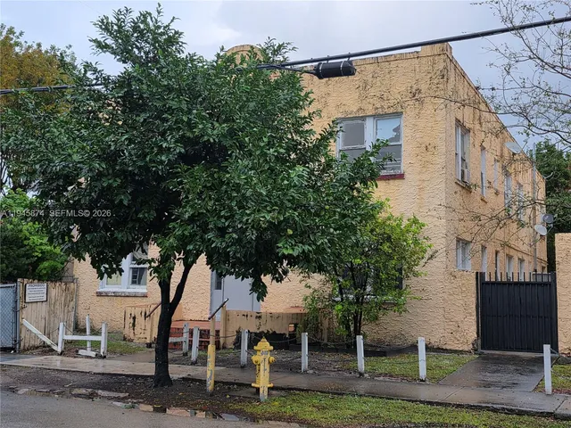 an outdoor space with seating area and trees