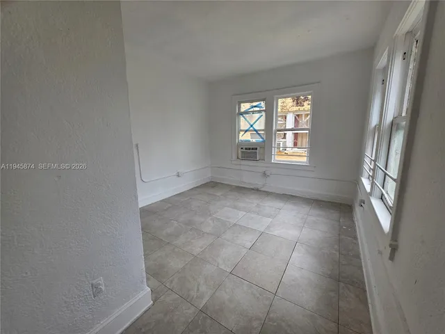 a view of an empty room with a window
