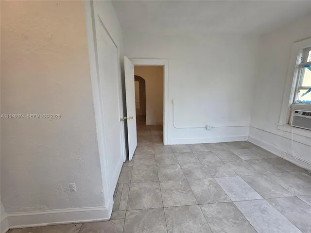 a view of a small space with wooden floor and a window