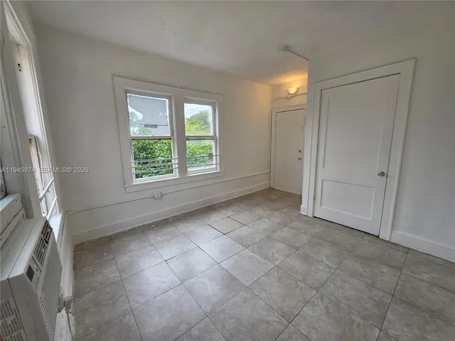 a view of an empty room with a window