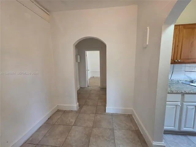 a view of a hallway with a cabinet and a mirror