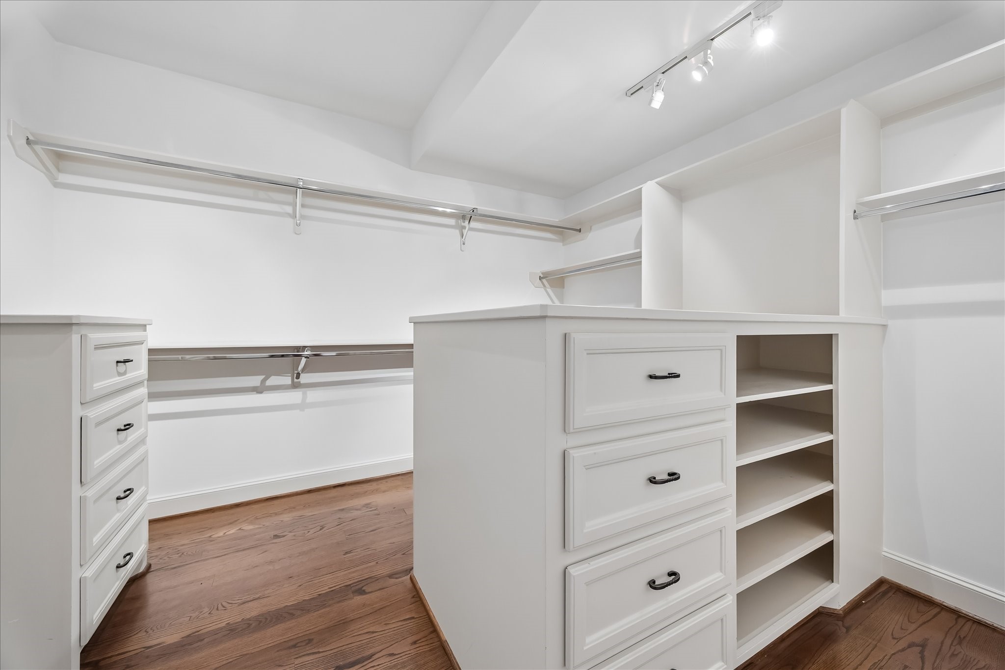 2246 Branard Street Houston, TX 77098 - Photo 30 of 40 An expansive primary closet with custom built-ins, center storage island, and abundant hanging space designed for effortless organization.